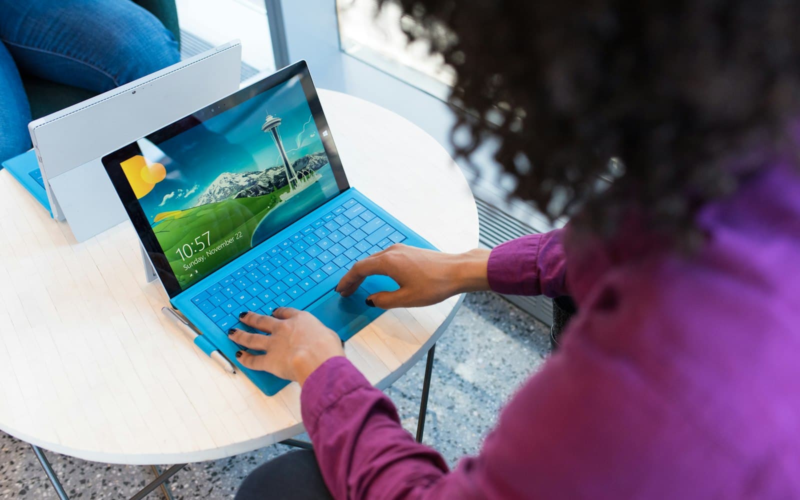 A professional at a laptop — Settings → Messaging is where the AiSensy key lives, encrypted, on the tenant.