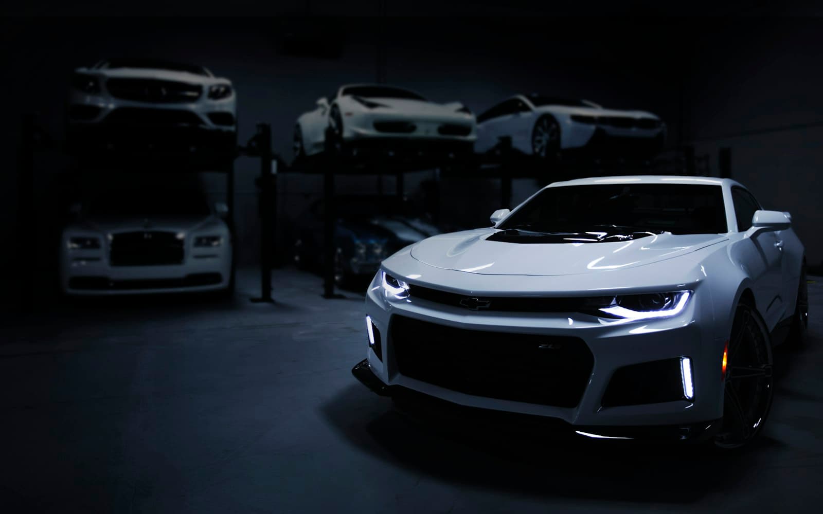 A sports-car headlamp in the showroom lights — if WhatsApp says available and the VIN is already allocated, you just leaked a booking.