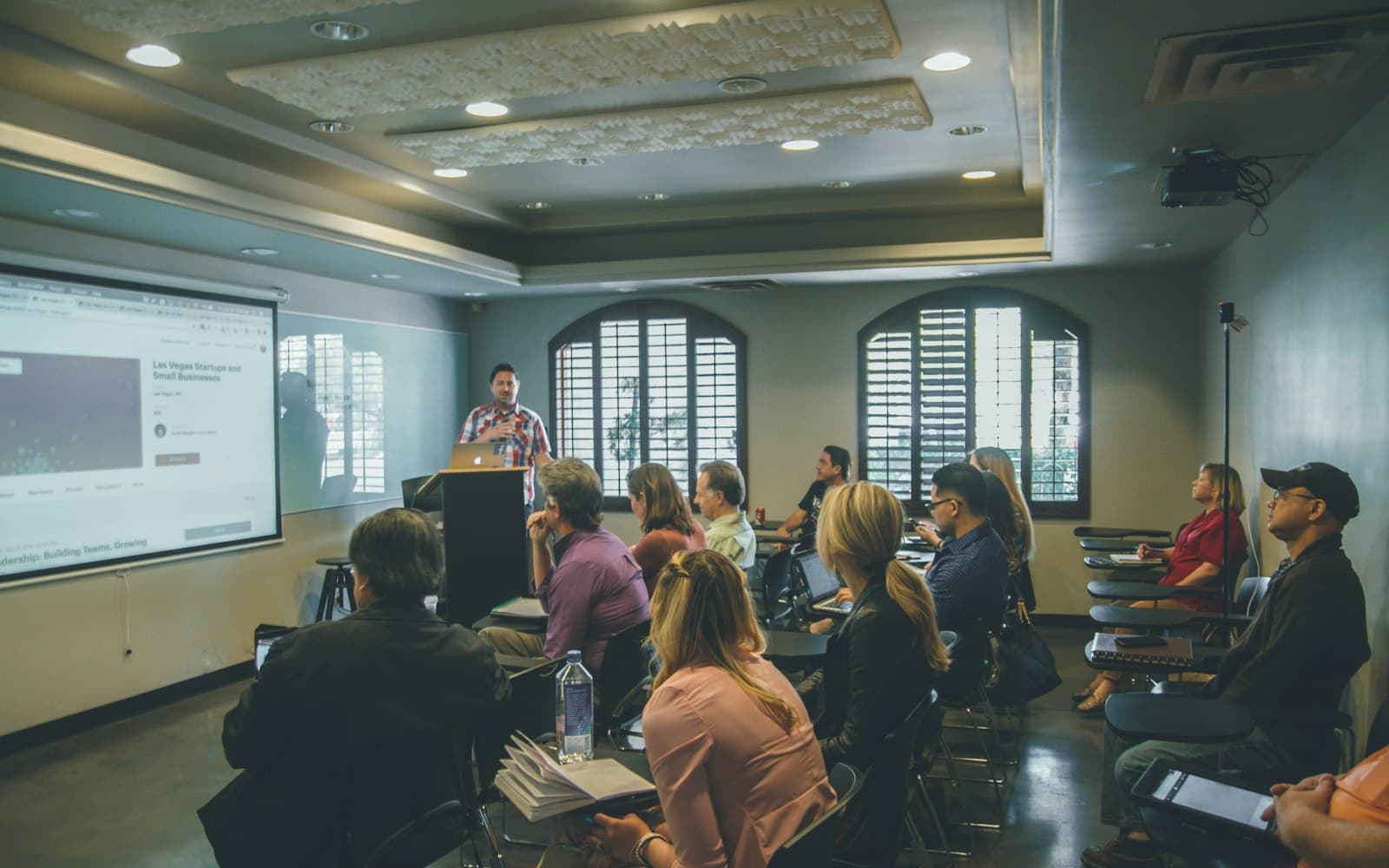 A lecture hall mid-session — the demo class is a CRM event, not a calendar invite that never made it back to the thread.