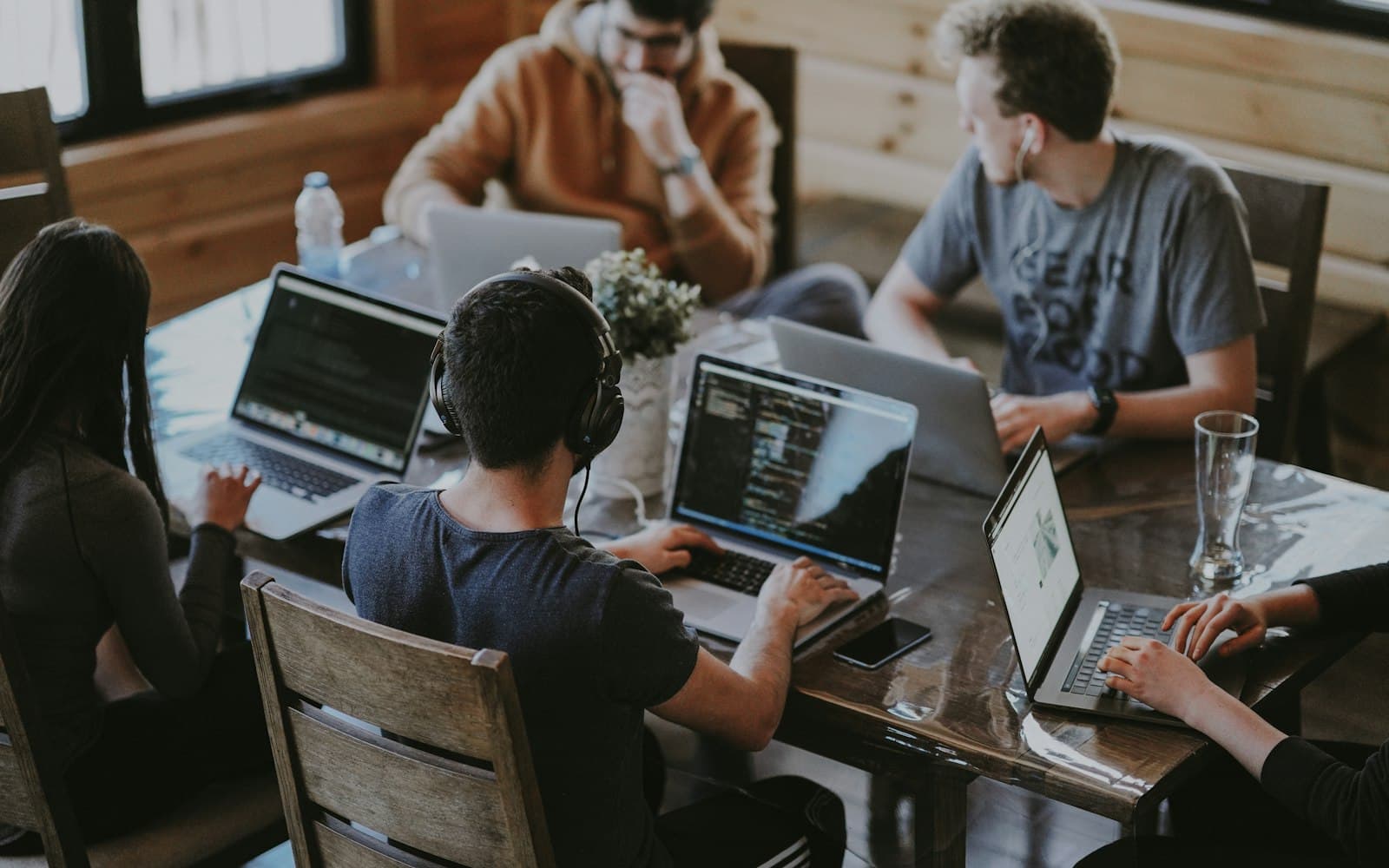 A working table of laptops — the client, the retainer and the case have to sit next to the WhatsApp that asked “any update?”