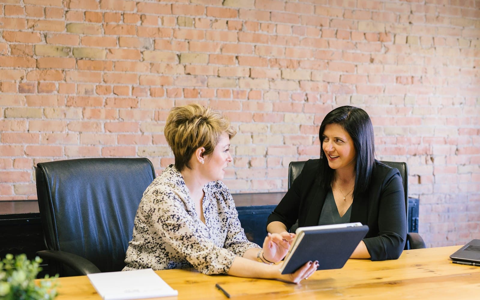 A review meeting over a tablet — the missing PDF is a CRM state; the account number is not.