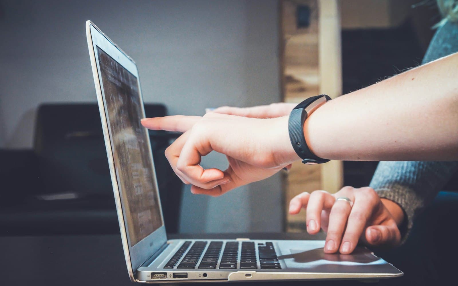 Hands on a laptop — the decision is whether the next hire can see yesterday’s thread without borrowing a phone.